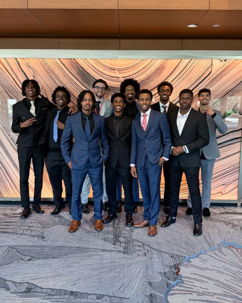 The Disciple Distributions team in business attire at a professional event